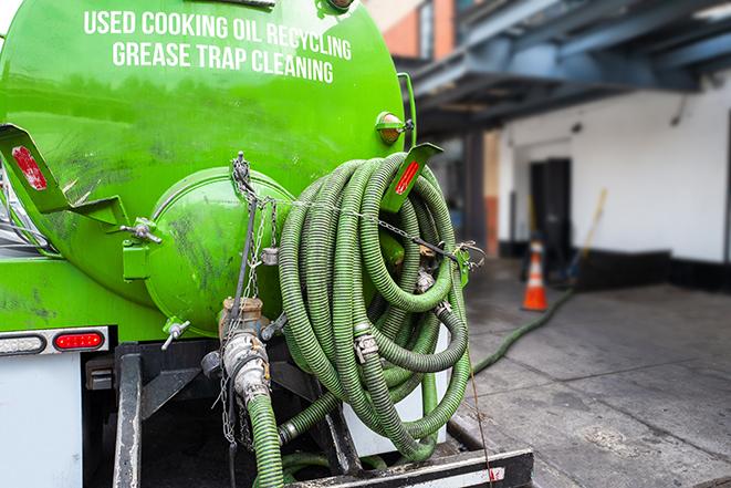 a technician pumping a grease trap in a commercial building in Cave Creek, AZ